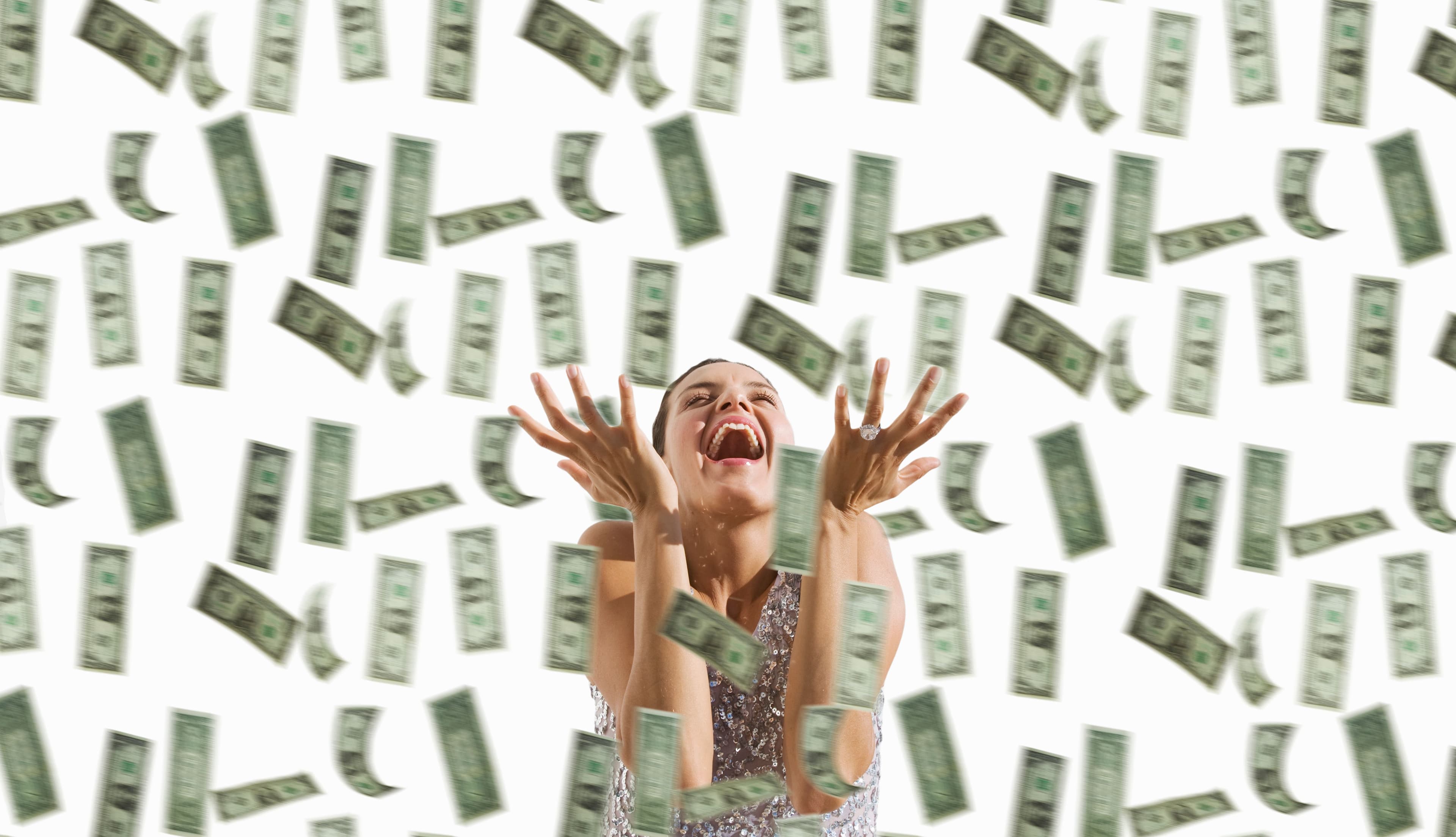 Woman with falling dollars.  (BuenaVistaImages/Gettyimages)