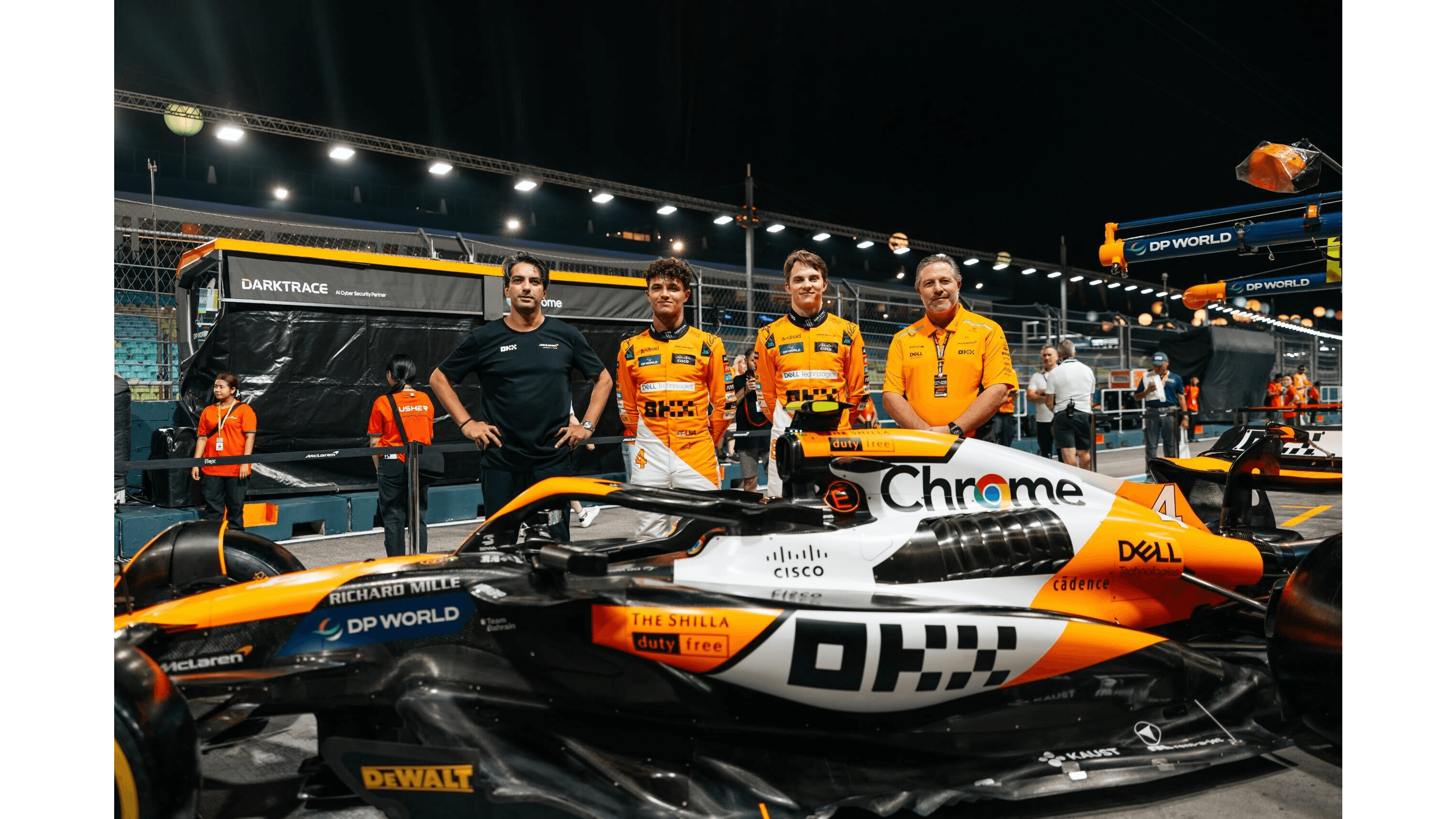 16:9 OKX CMO Haider Rafique with McLaren drivers Lando Norris and Oscar Piastri before the Singapore Grand Prix on September 1, 2024. (Courtesy: McLaren and OKX)