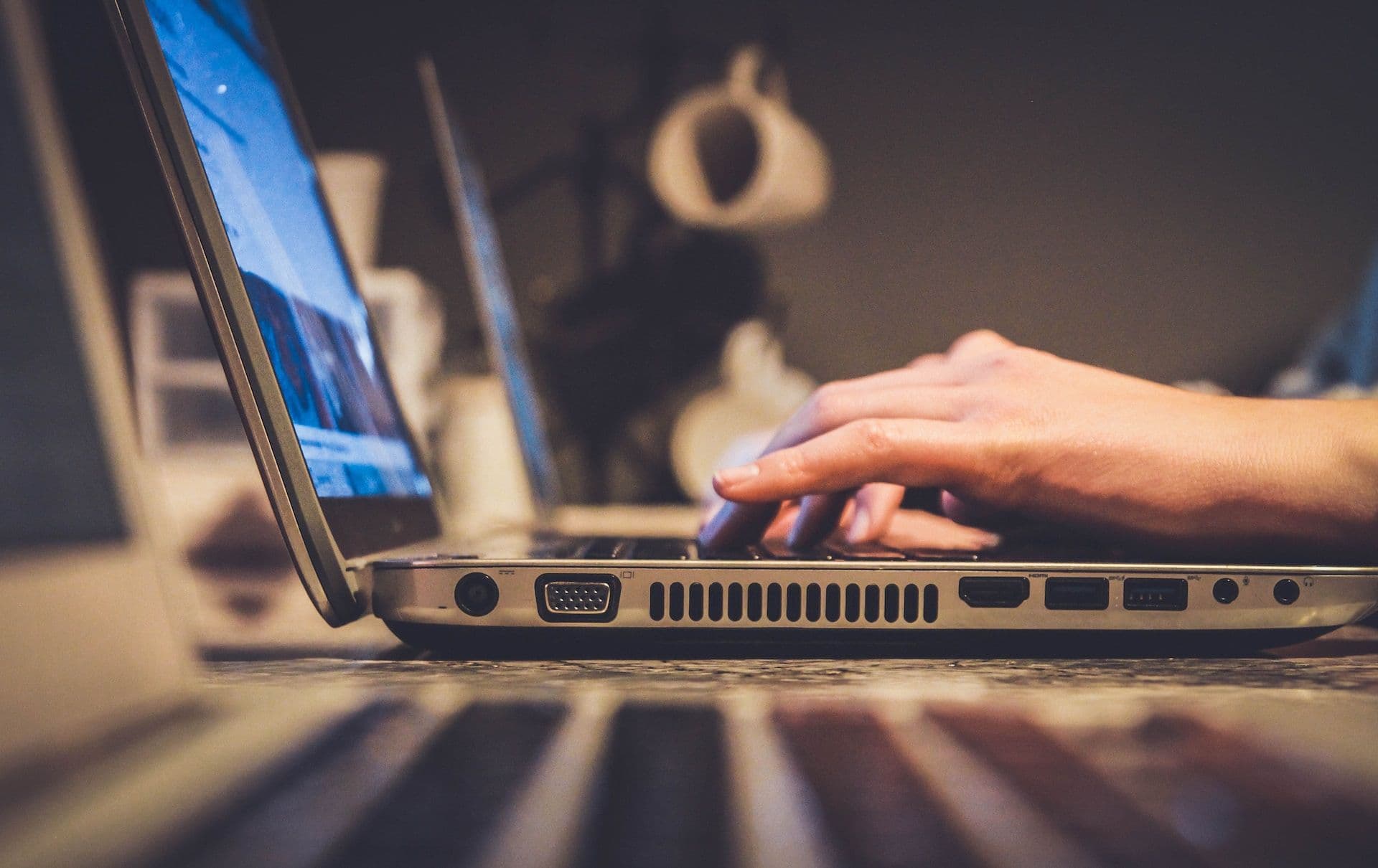 An illustration of someone using a laptop to surf the internet (John Schnobrich/Unsplash)