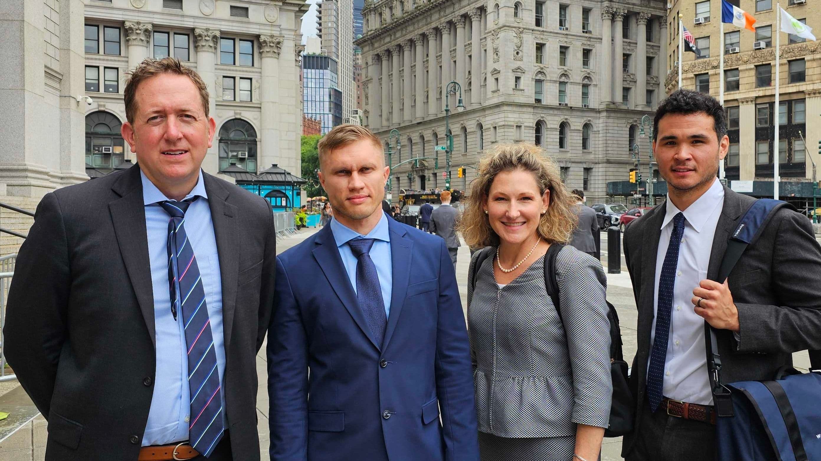 Tornado Cash's Roman Storm, second from left, and his legal team outside court in New York (Nik De/CoinDesk)