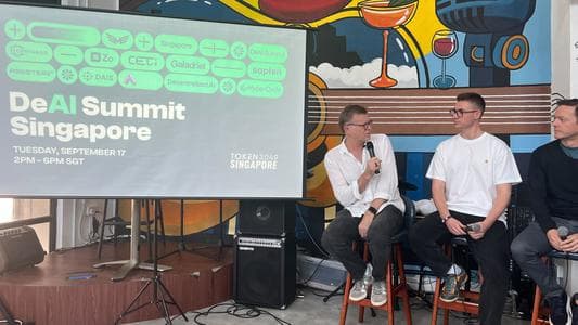 DAIS Chair Michael Casey moderating a panel at the DeAI Summit Singapore