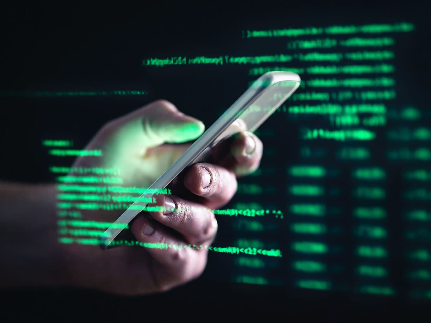 CDCROP: Darkweb, darknet and hacking concept. Hacker with cellphone. Man using dark web with smartphone. Mobile phone fraud, online scam and cyber security threat. Scammer using stolen cell. (Getty Images)