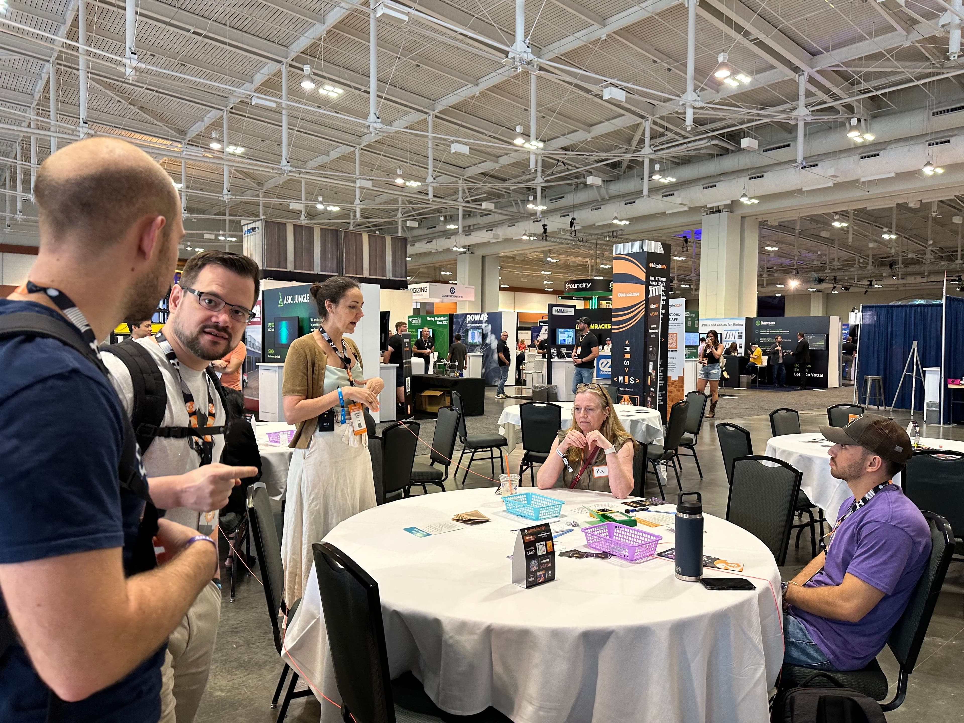 Bitcoin Lightning protocol engineer and Bitcoin++ founder Lisa Neigut teaching a class at a Bitcoin Nashville side table near the Open Source Stage (Bradley Keoun)